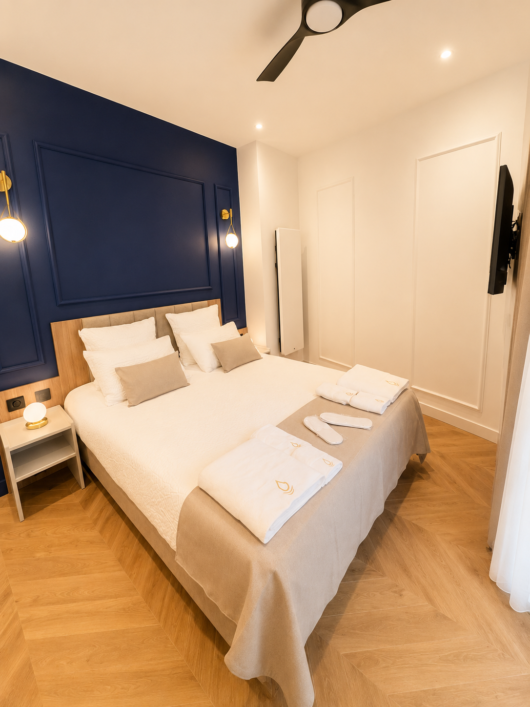 Chambre lit Queen size et mur bleu saphir, Appart' Deluxe avec Véranda